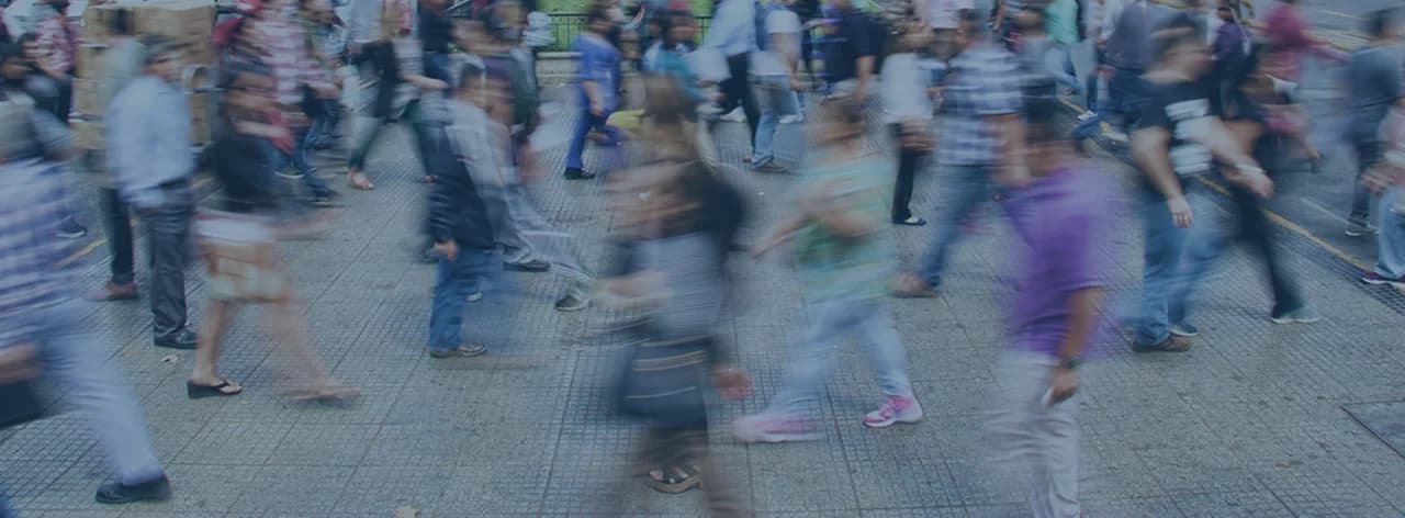 Hero image for Sparta Biomedical, featuring a motion-blurred crowd of pedestrians walking on a busy city sidewalk with a blue color overlay.
